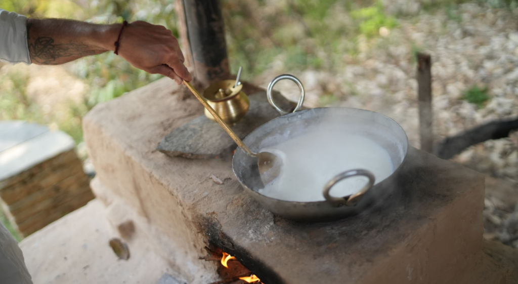 Cooking khoya over an open flame to prepare Bal Mithai in Uttarakhand”