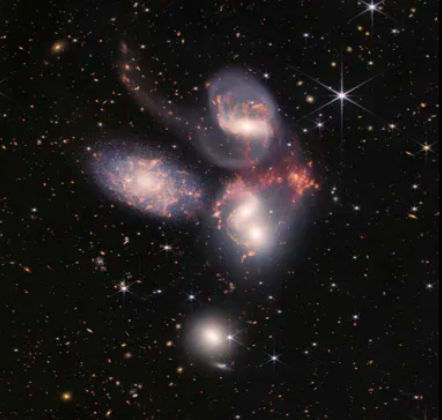 Image of a galactic collision with vibrant colors and dynamic interaction between multiple galaxies