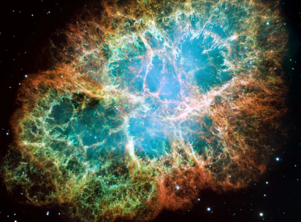 The Crab Nebula as seen through the James Webb Space Telescope, displaying the intricate details of a supernova remnant