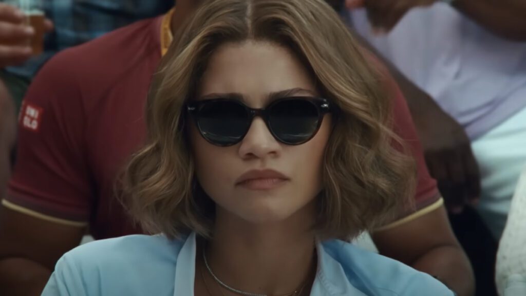 Zendaya wearing sunglasses, watching Mike Faist & Josh O'Connor's match in Challengers.