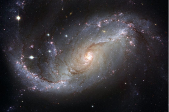 A close-up view of a magnificent spiral galaxy, showcasing swirling arms and bright star clusters.